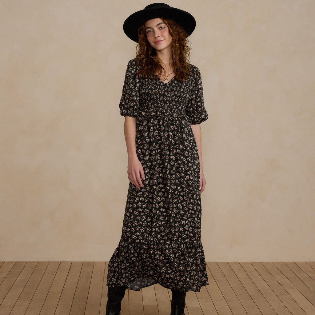 dark floral dress on women with hat 