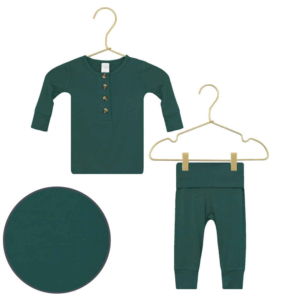 flatlay of top and bottom in green on white background 