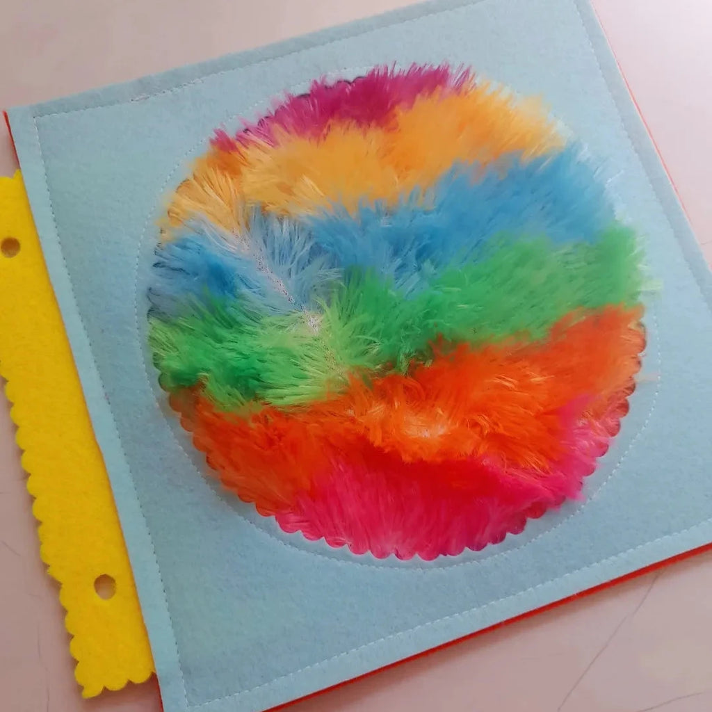 rainbow fuzzy on blue background flat lay