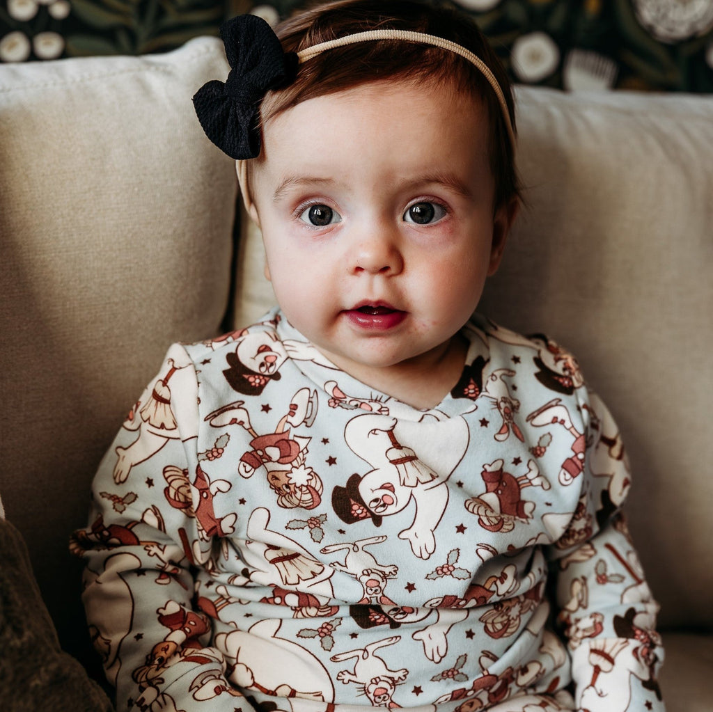 snowman sweatshirt girl with black bow in hair