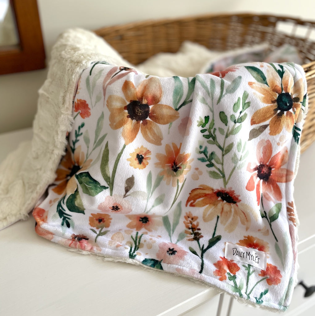 floral fall blanket in wicket basket 