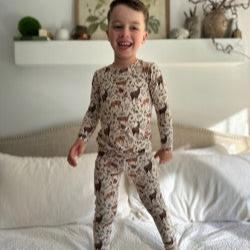 Two Piece PJ set on boy standing on bed