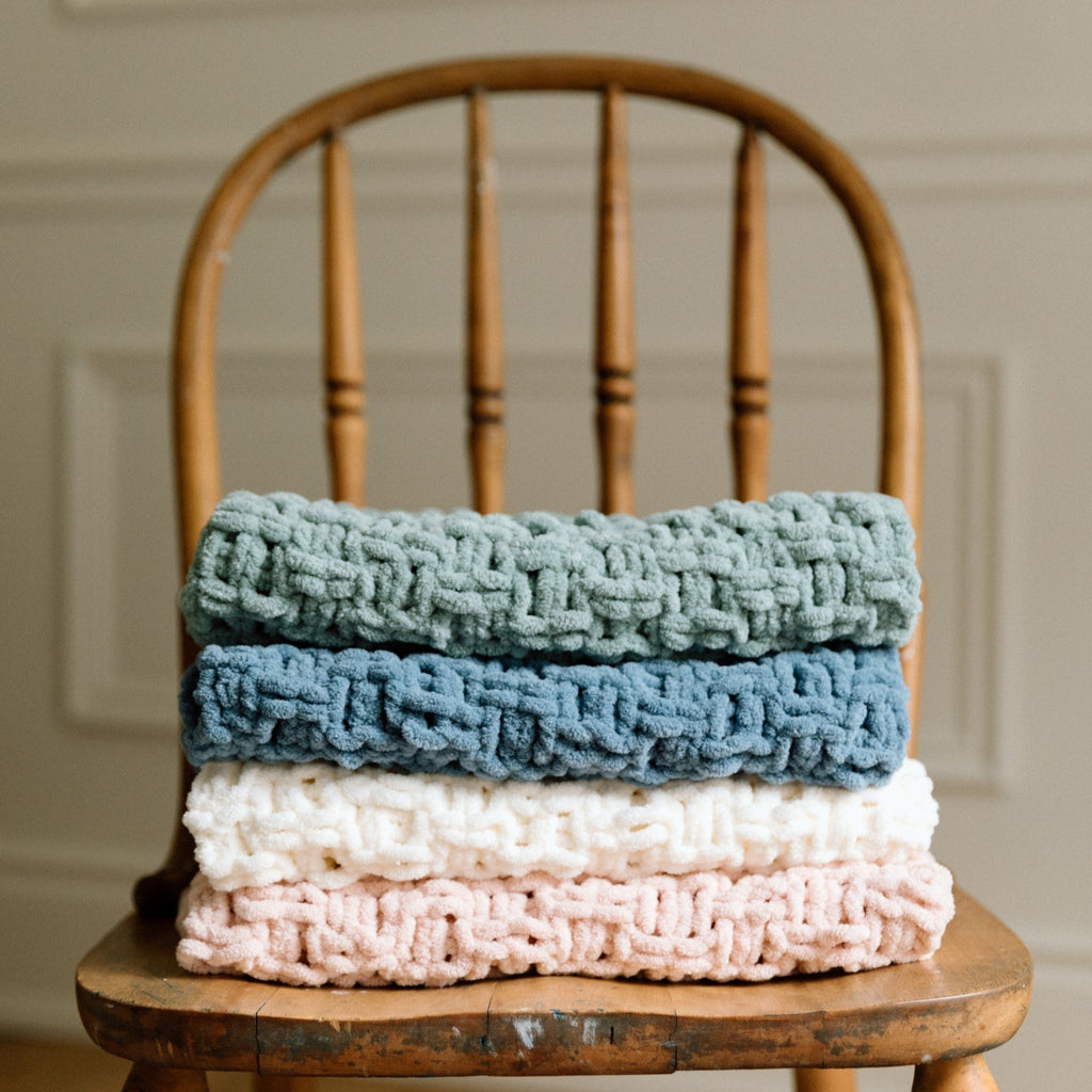 green,blue,white,pink blanket on chair