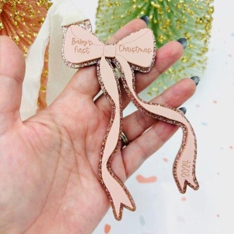 pink bow ornament in hand