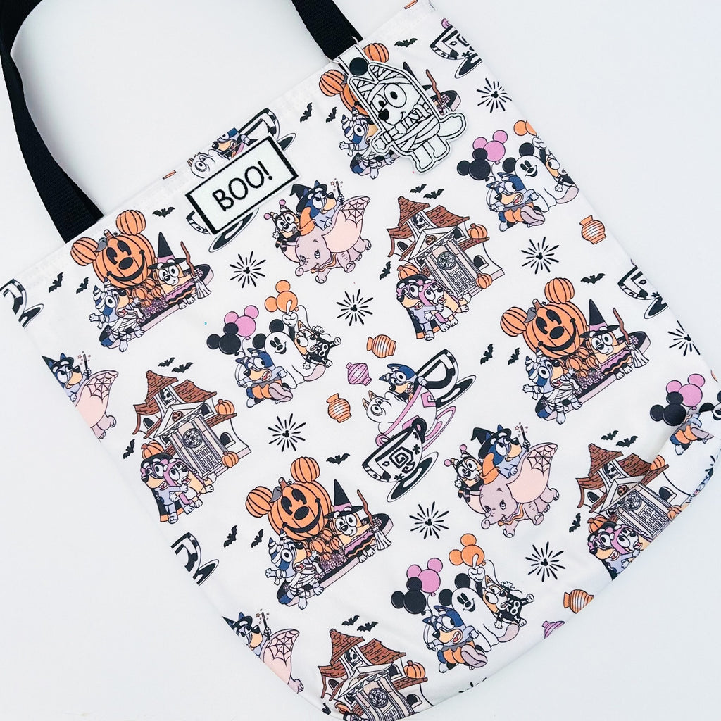 flatlay of dogs and mouse on halloween bag