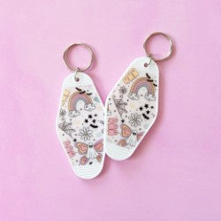 butterfly ghost keychain on pink background