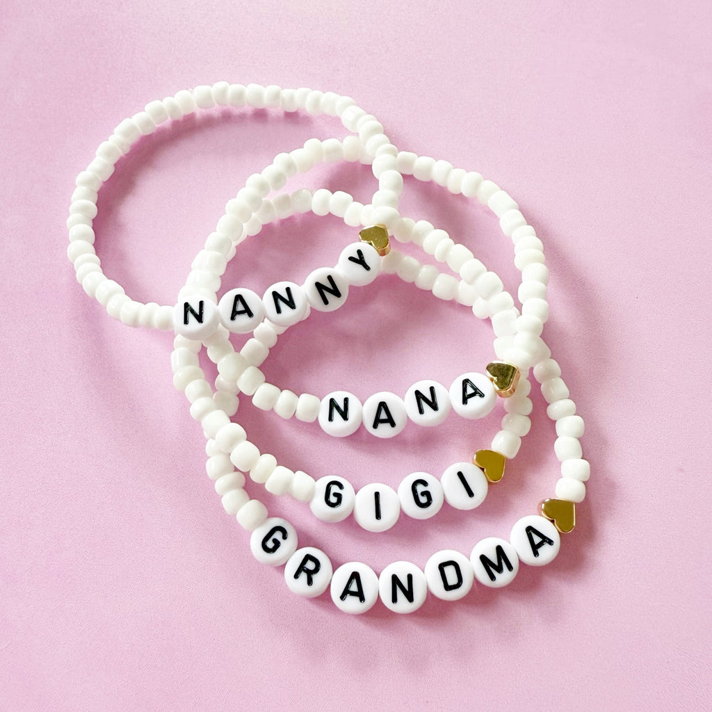 nanny,nana,gigi,grandma white seed bracelet with gold heart flat lay