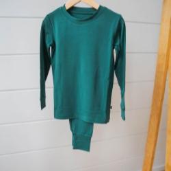 green pj hanging on wooden rack