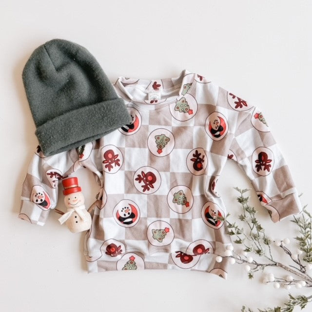 sugar cookie crew neck with grey hat and snowman flat lay