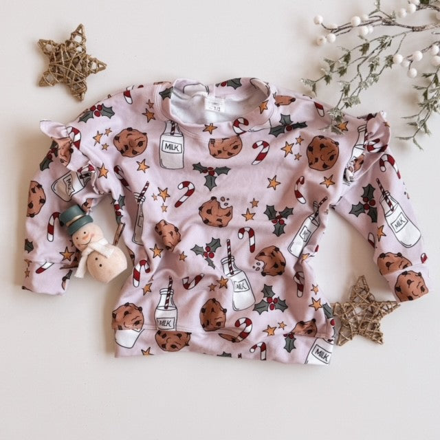 pink crew neck with milk and cookie and candy canes flat lay