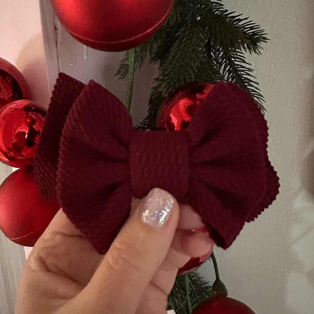 maroon waffle bow held in hand