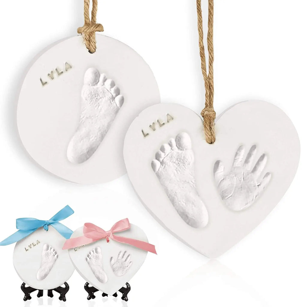 White background with 2 Adore Ornament Keepsakes by KeaBabies hanging, and 2 of them on the bottom left with ribbons on the top. Ornaments are round, and heart shaped, and show feet and hand princts.