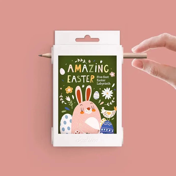 Fun Easter Stuffer Game by Scrollino with a hand touching a pencil, with a pink background