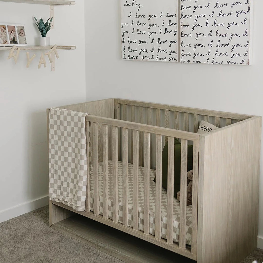 Taupe Checkered Crib Sheet by Mebie Baby in a nursery with i love you canvas art name wyatt hanging