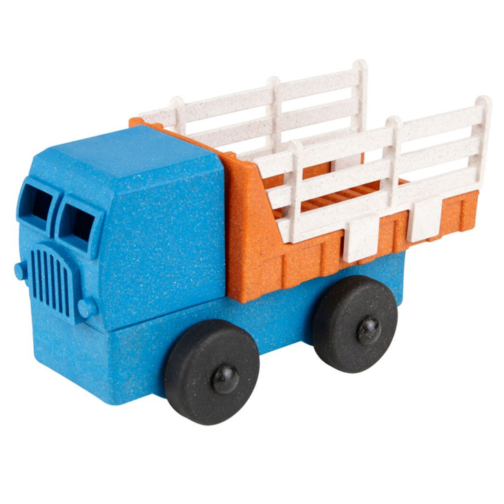 White background with 3D Stake Truck by Luke's Toy Factory. Front & bottom of the truck are blue, and the trick bed is orange with white rails.