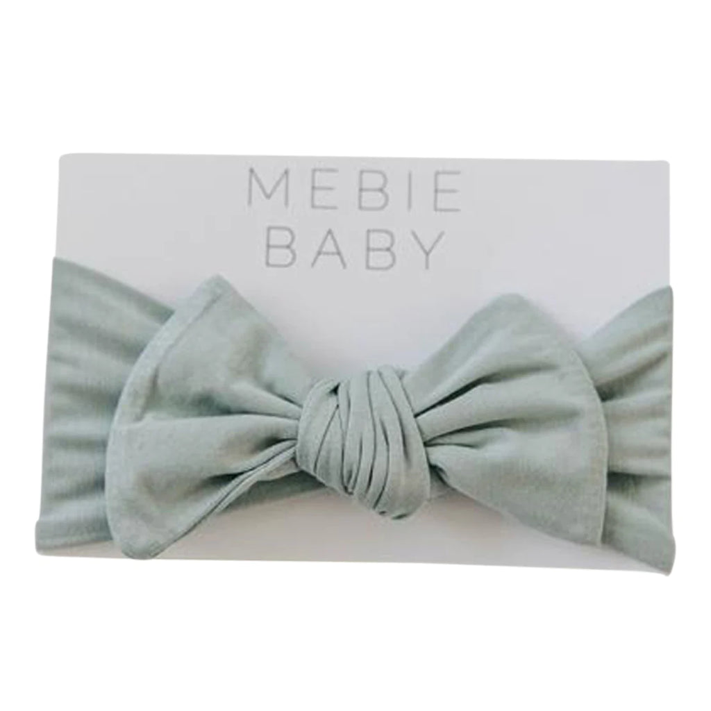 White background with packaging of the Sage Head Wrap by Mebie Baby.
