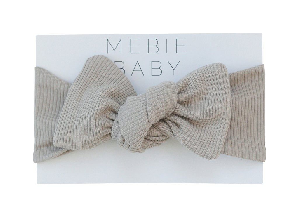 White background with packaging for Oatmeal Organic Cotton Ribbed Head Wrap by Mebie Baby.
