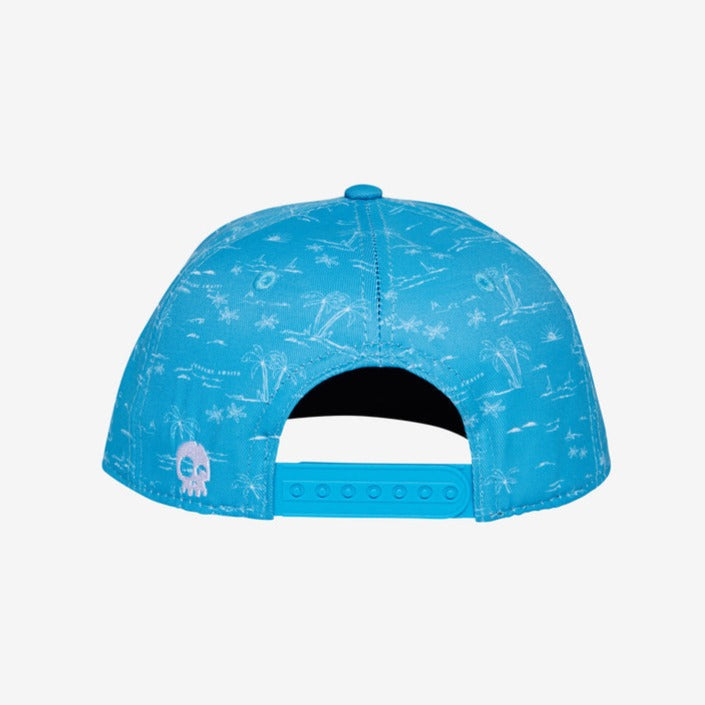 Adventure Awaits Blue Snapback by Headster with a white background and surface. 