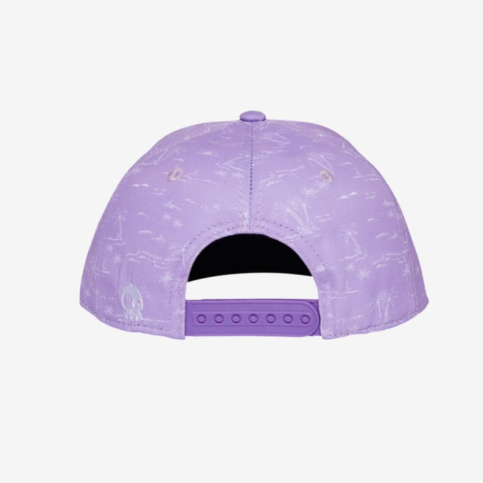 Adventure Awaits Lilac Snapback by Headster with a white background and surface. 