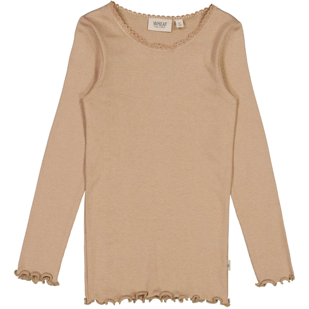 White background with RIb T-Shirt Lace Long Sleeve in Affogato by Wheat Kids Clothing. T-Shirt has long sleeves with lacy details around the collar, it's ribbed in a soft beige/brown colour, with ruffles on the sleeves and edges.