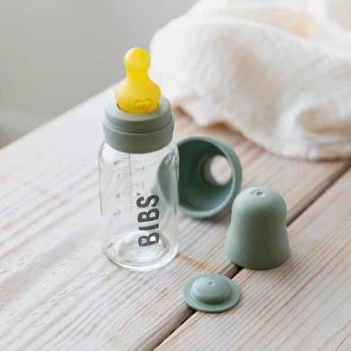 White wash table with a Complete Bottle Set in Sage, and a Latex Bottle NIpple by Bibs.