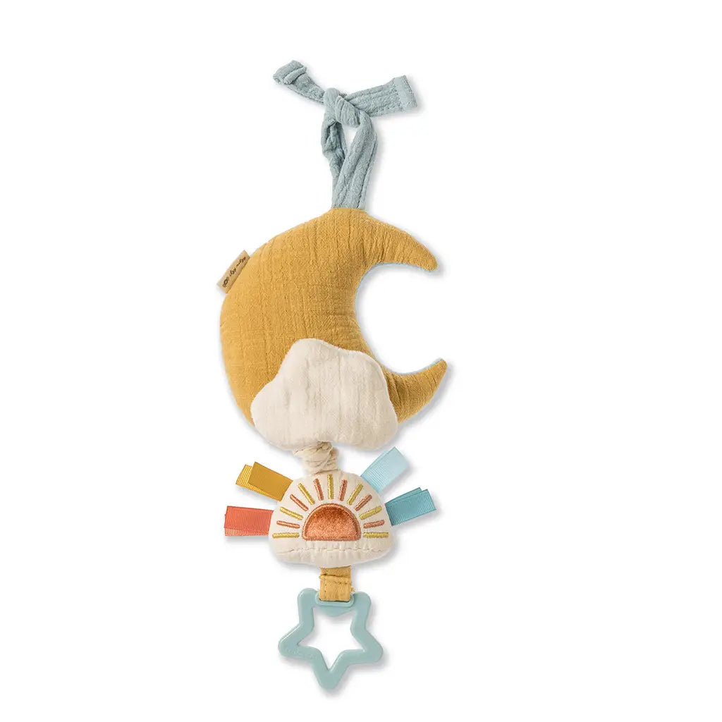 White background with Bitzy Notes™ Musical Pull-Down Toy Cloud/Sun by Itzy Ritzy. Toy is an ochre moon with a sun attached with taggies, and a star teether.