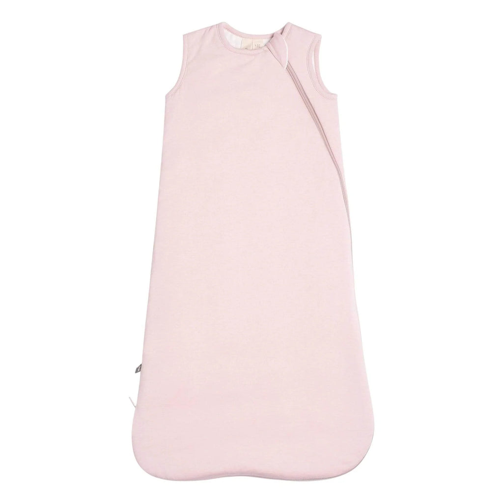 White background with Sleep bag 1.0 Tog in Blush by Kyte Baby. Sleep bag is a pale pink colour with a zipper that goes from the front left shoulder all the way down the side & bottom.