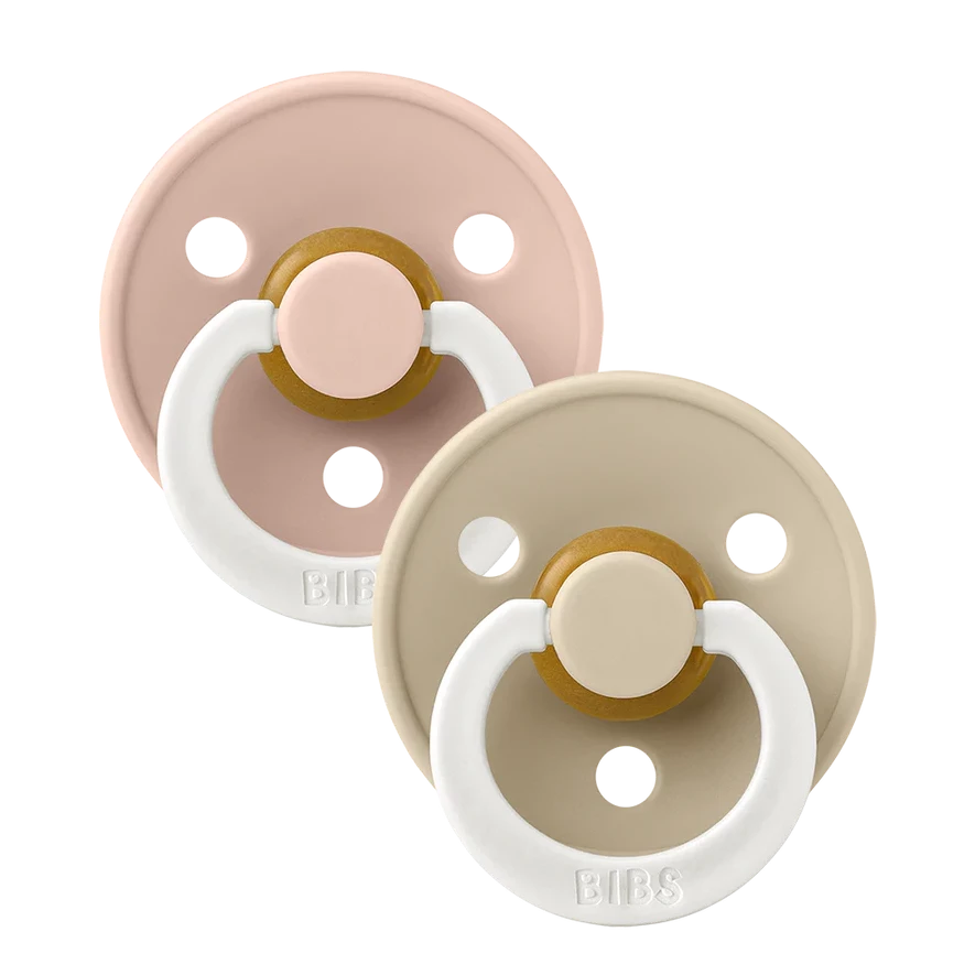 Clear background with the Size 2 Pacifiers in Blush Night and Vanilla Glow by Bibs. Pacifier is black with a white handle, and it glows in the dark.