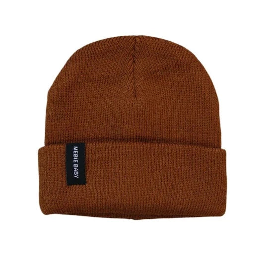 White background with Brown Beanie by Mebie Baby. Beanie is a warm medium brown, with a cuff, and a black rectangular tag that says "Mebie Baby" in white.