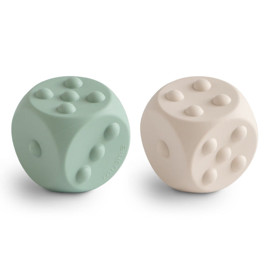 Dice Press Toy 2-Pack by Mushie in Cambridge Blue and Shifting Sand. 