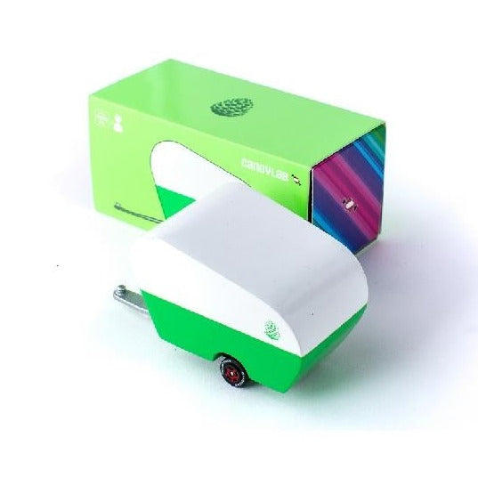 White background with green packaging, and a green candycar trailer with pinecone.