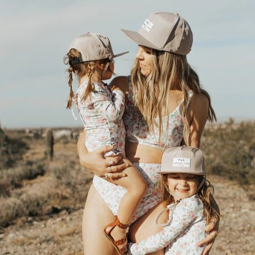 Woman holding little girl, with a second little girl at her side.. all wearing Champagne Made For Shae;d Waterproof Snapback by Current Tyed Clothing
