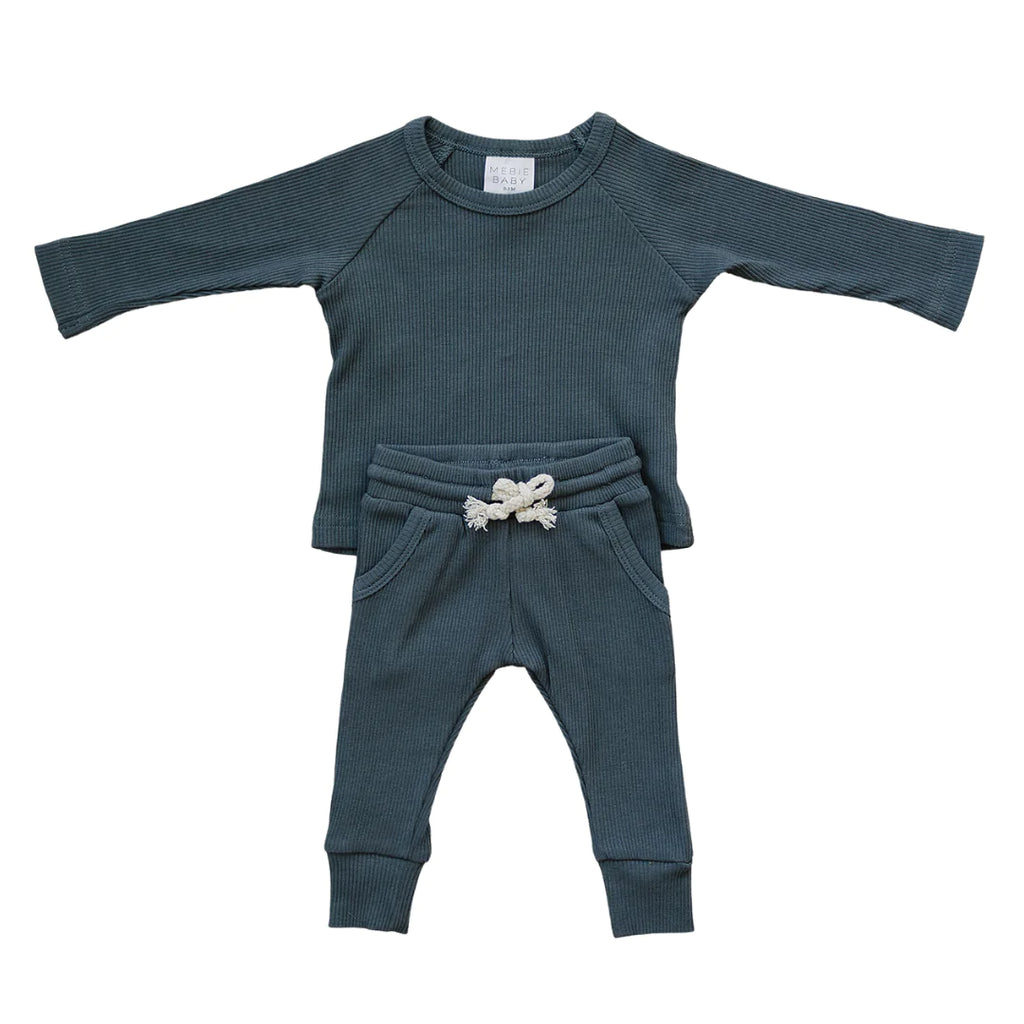 White background with Charcoal Organic Cotton Ribbed Pocket Set by Mebie Baby. This is a two piece set in a charcoal ribbed fabric. Long sleeve top, with tie waist pants, with front pockets.