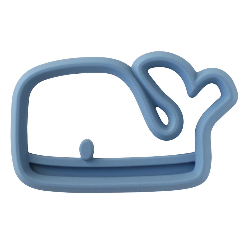 White background with a Chew Crew Silicone Baby Teether in Whale by Itzy Ritzy. Teether is a medium blue and shaped like a whale.