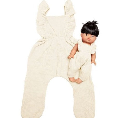 White background with The Maya Jumpsuit for Child and Doll by Minikane, the doll jumpsuit is dressed on a doll.