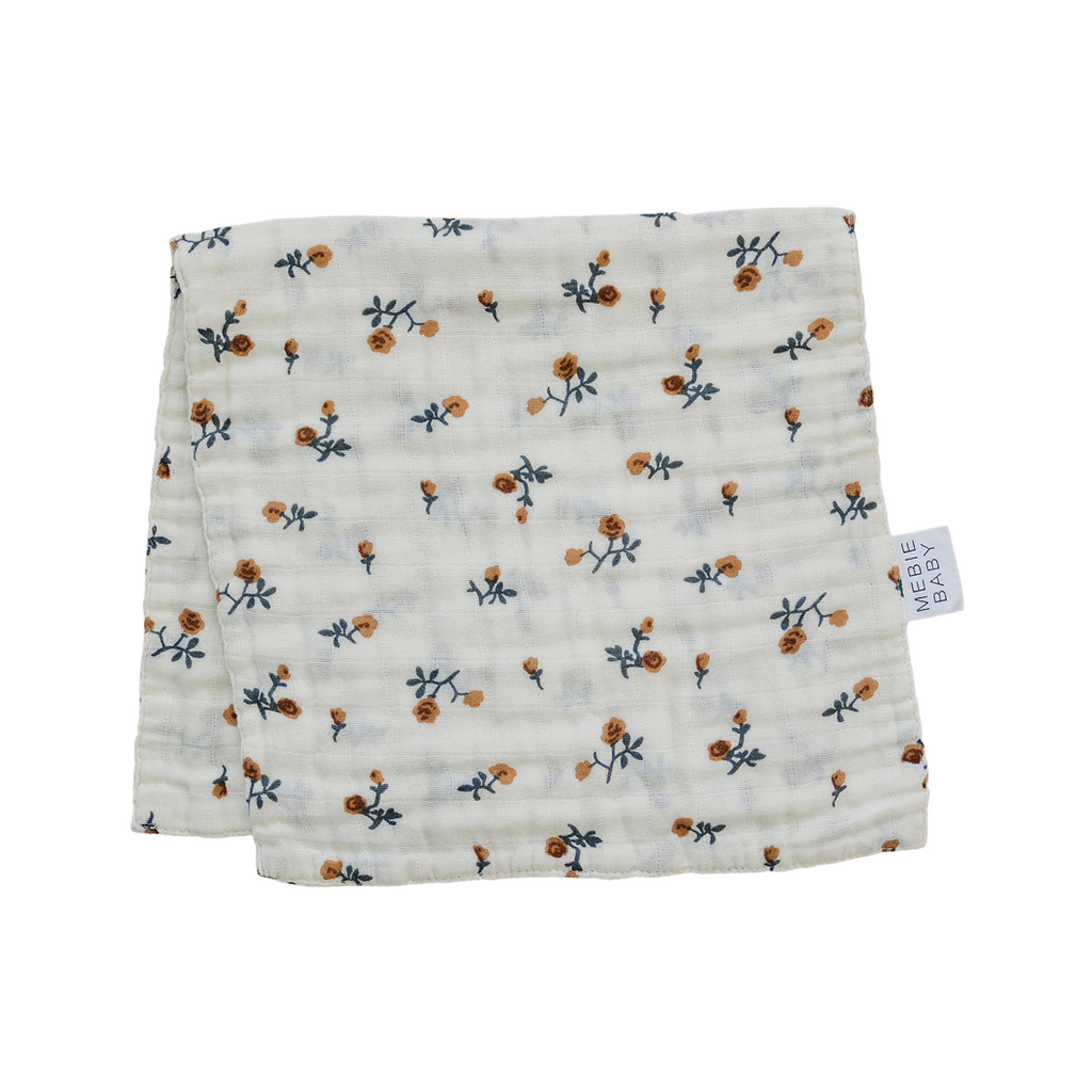 Cream Floral Burp Cloth by Mebie Baby, in front of a white background. 