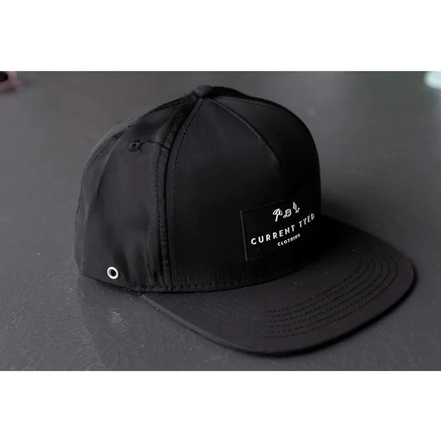 Made For Shae'd Waterproof Hat by Current Tyed Clothing. Laid on a flat black surface. 