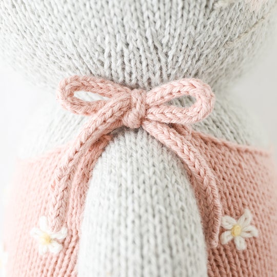 Up Close showing knitted sleeve detail of small bow on Daisy The Kitten by Cuddle and Kind