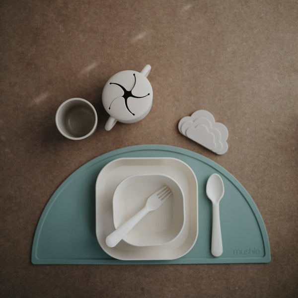 Beige background with an overhead view of a table setting, and the Square Dinnerware Bowls Set of 2 by Mushie.