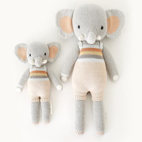 White background with Evan The Elephant by Cuddle and Kind, both sizes laying side by side.