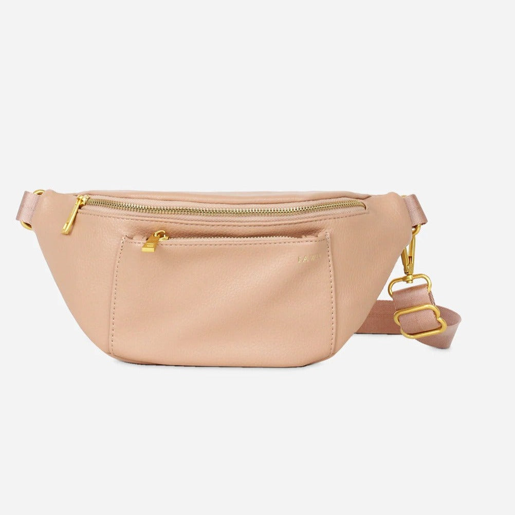 White background with The Fawny Pack in Warm Blush by Fawn Design. Fawny pack is a warm light pink colour with gold zippers and details.