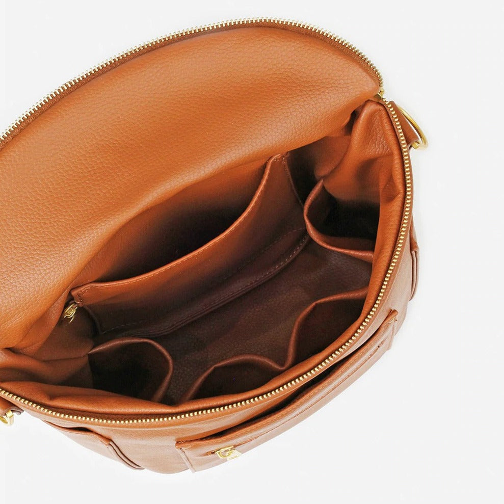 White background with overhead view of Mini Bag in Brown by Fawn Design. Colour is a warm brown, and shows the inside pockets