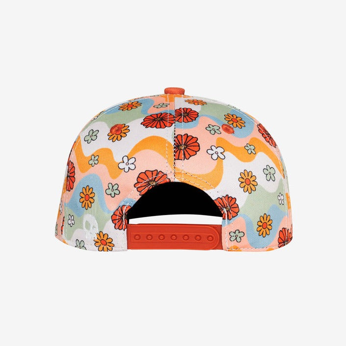 Flower Patch Squash Snapback by Headster white background and surface. 