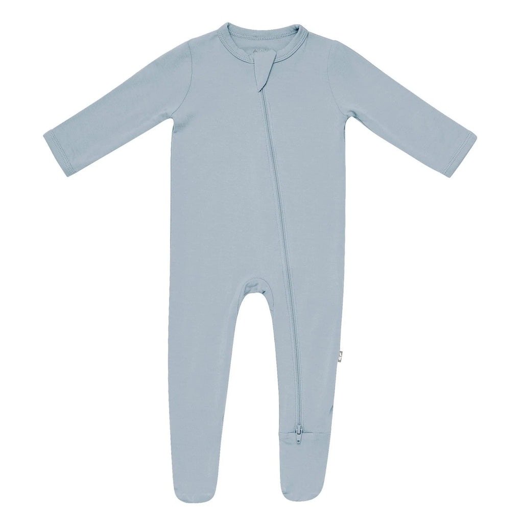 White background with a Zippered Footie in Fog by Kyte Baby. Zippered footie in blue fog with a zipper going down the front.
