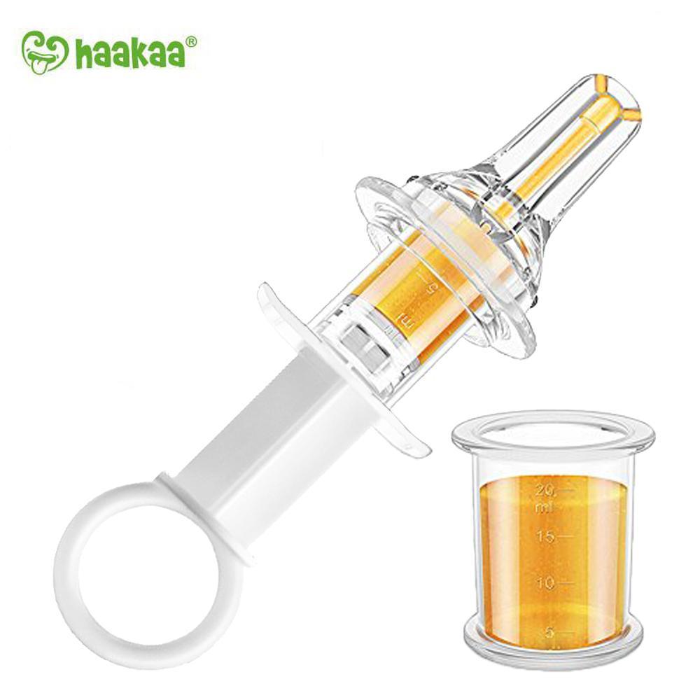 White background with Oral Feeding Syringe by Haakaa.