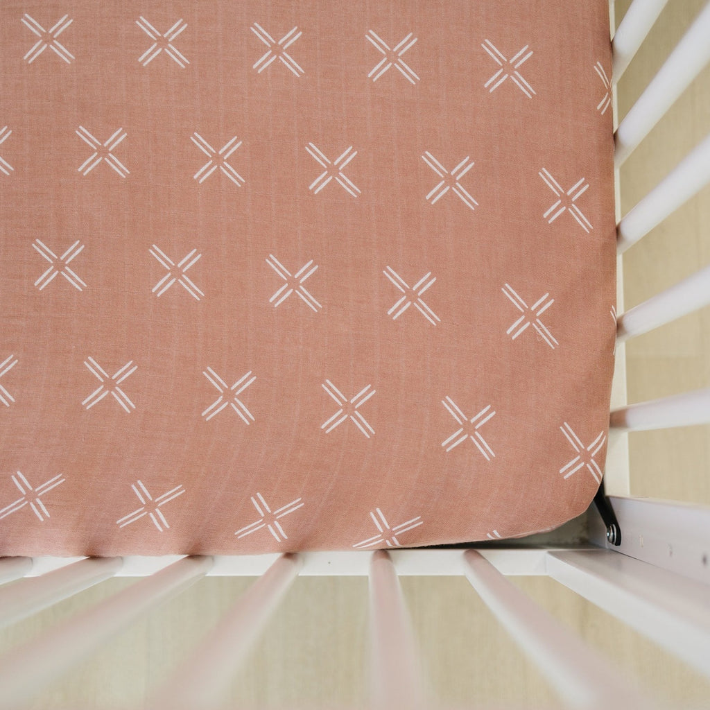 Just Peachy Crib Sheet by Mebie Baby on a crib mattress, within a white crib. 