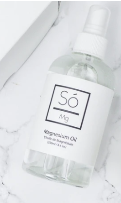 Overhead view of the Magnesium Oil by So Luxury Bath and Body Inc on a white marble counter.