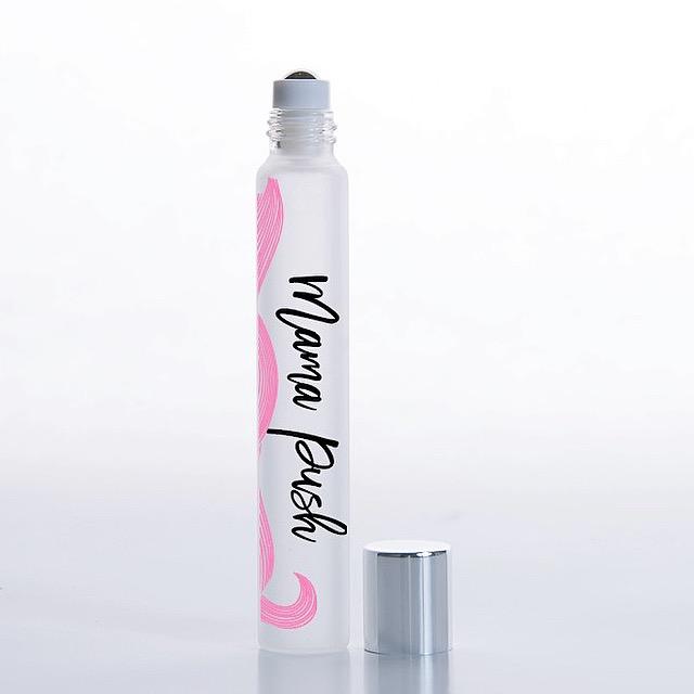 White background with rollerball of Mama Push Essential Oil Blend by Jane + Thunder.