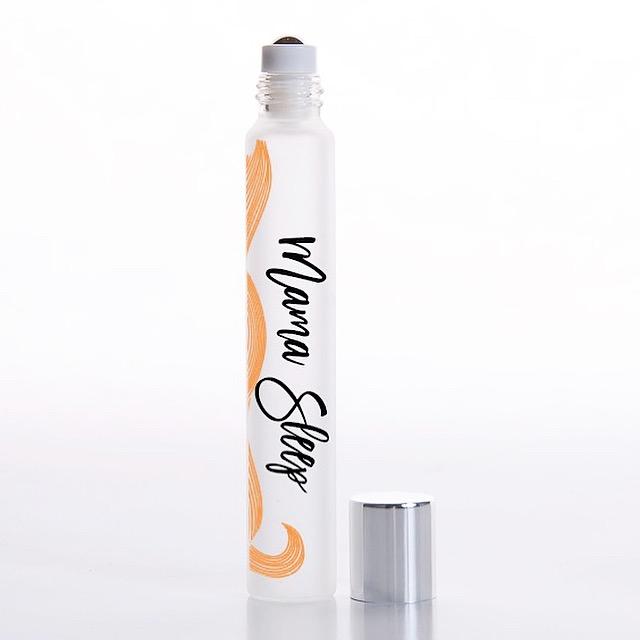 White background with rollerball of Mama Sleep Essential Oil Blend by Jane + Thunder.