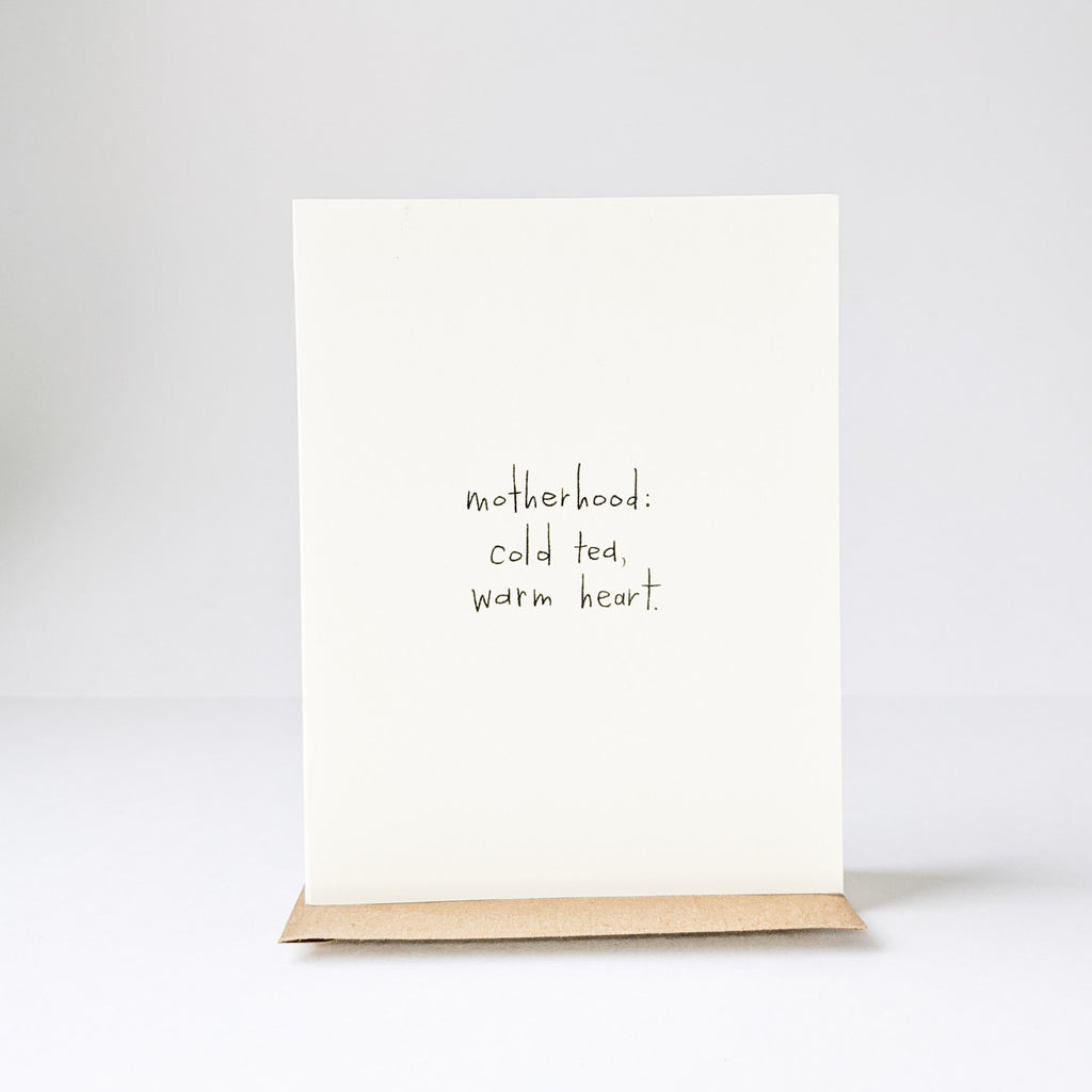 White background with the Motherhood: Cold Tea, Warm Heart. Card by Under The Stairs Paper Co.